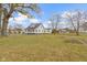 White farmhouse with wraparound porch and landscaping at 26735 Six Points Rd, Sheridan, IN 46069