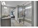 Bathroom with double vanity, walk in shower, and view of bedroom at 3628 Planck Cir, Danville, IN 46122