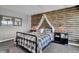 Cozy bedroom, wood-paneled accent wall, metal bed frame at 3628 Planck Cir, Danville, IN 46122
