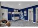 Fun bedroom with a bunk bed, navy walls, and car art at 3628 Planck Cir, Danville, IN 46122