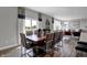 Open concept dining area with a large wooden table and modern chairs at 3628 Planck Cir, Danville, IN 46122