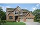 Two-story home with brick and siding exterior, two-car garage, and landscaping at 3628 Planck Cir, Danville, IN 46122
