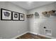 Bright laundry room with wood-look floors, shelving, and stylish wall art at 3628 Planck Cir, Danville, IN 46122