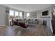 Living room featuring a sectional sofa, fireplace, and large windows at 3628 Planck Cir, Danville, IN 46122