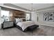 Main bedroom with wood accent wall, plush bed, and en-suite bathroom at 3628 Planck Cir, Danville, IN 46122