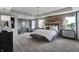 Luxurious main bedroom with wood feature wall, plush bed, and sitting area at 3628 Planck Cir, Danville, IN 46122
