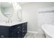 Double vanity bathroom with marble tile and freestanding tub at 408 W 11Th St, Anderson, IN 46016