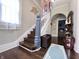 Elegant entryway featuring a grand staircase and hardwood floors at 408 W 11Th St, Anderson, IN 46016