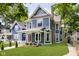 Charming blue two-story home with a landscaped lawn and walkway at 408 W 11Th St, Anderson, IN 46016