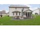 Rear view of house, showcasing patio and screened porch at 7935 Shannon Lakes Way, Indianapolis, IN 46217