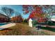 Landscaped backyard featuring a storage shed and autumn leaves at 1160 Mt Vernon Dr, Greenwood, IN 46142