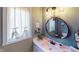 Chic bathroom boasts a round mirror, updated vanity, and decorative accents at 1160 Mt Vernon Dr, Greenwood, IN 46142