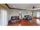 Living room with hardwood floors and two leather sofas at 1160 Mt Vernon Dr, Greenwood, IN 46142