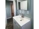 Bathroom with vanity, mirror, and a view of hallway at 1601 Draper St, Indianapolis, IN 46203