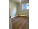 Simple bedroom with wood-look flooring and a window at 1601 Draper St, Indianapolis, IN 46203