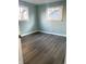 Bright bedroom with two windows and wood-look flooring at 1601 Draper St, Indianapolis, IN 46203