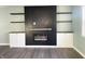 Modern electric fireplace with white cabinets and floating shelves at 1601 Draper St, Indianapolis, IN 46203