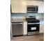 Modern kitchen featuring stainless steel appliances and white cabinets at 1601 Draper St, Indianapolis, IN 46203
