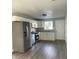 Modern kitchen with white cabinets, stainless steel appliances, and hardwood floors at 1601 Draper St, Indianapolis, IN 46203