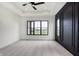 Main bedroom with gray carpet, black accent wall, and large windows at 5035 Abington Way, Zionsville, IN 46077