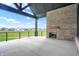 Covered patio with fireplace and backyard views at 5035 Abington Way, Zionsville, IN 46077
