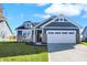 New single-story home with gray siding, stone accents, and a two-car garage at 7139 Rose Hill Ave, Brownsburg, IN 46112