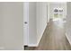 Long hallway with light gray walls and wood-look flooring at 7139 Rose Hill Ave, Brownsburg, IN 46112