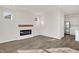 Living room with a modern fireplace and wood-look flooring at 7139 Rose Hill Ave, Brownsburg, IN 46112