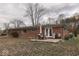 Brick home's backyard features a patio, seating area, and grill at 8190 Beech Grove Rd, Martinsville, IN 46151