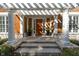 Front entrance with a pergola, stone columns, and a wooden door at 10902 Forest Lake Ct, Indianapolis, IN 46278