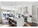 Modern kitchen with white cabinets, stainless steel appliances, and a large island at 13613 Lake Ridge Ln, Fishers, IN 46055