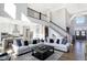 Open concept living room with two sofas and a view to the kitchen and staircase at 13613 Lake Ridge Ln, Fishers, IN 46055