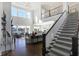 Two-story living room with hardwood floors, high ceilings, and a view to the kitchen at 13613 Lake Ridge Ln, Fishers, IN 46055