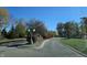 Landscaped entrance to the community with curving road at 2327 Saddle Dr, Shelbyville, IN 46176