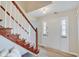 Bright entryway with hardwood floors and a view of the staircase and kitchen at 4902 N Capitol Ave, Indianapolis, IN 46208