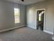Spacious bedroom with carpeting, large window, and access to bathroom at 503 E Clyde St, Frankton, IN 46044