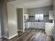 Modern kitchen featuring white cabinets, granite countertops, and wood flooring at 503 E Clyde St, Frankton, IN 46044