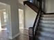Elegant staircase with dark wood railings and gray carpeting at 503 E Clyde St, Frankton, IN 46044