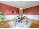 Elegant dining room with hardwood floors, a chandelier, and a modern table at 781 Woodruff Pl W Dr, Indianapolis, IN 46201