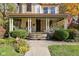 Inviting front porch with wicker furniture, perfect for relaxing at 781 Woodruff Pl W Dr, Indianapolis, IN 46201