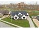 Luxury home with a modern design and a large yard at 10771 Holliday Farms Blvd, Zionsville, IN 46077