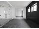 Finished basement with glass doors and dark wood paneling at 10771 Holliday Farms Blvd, Zionsville, IN 46077