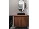 Contemporary powder room with a black sink and wood vanity at 10771 Holliday Farms Blvd, Zionsville, IN 46077