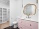 Bathroom with pink vanity, gold fixtures, and a unique mirror at 10771 Holliday Farms Blvd, Zionsville, IN 46077