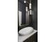 Modern bathroom with a sleek white sink and dark walls at 10771 Holliday Farms Blvd, Zionsville, IN 46077