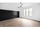Bright bedroom with black and white accent wall and hardwood floors at 10771 Holliday Farms Blvd, Zionsville, IN 46077