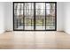 Bedroom with hardwood floors and sliding glass doors leading to deck at 10771 Holliday Farms Blvd, Zionsville, IN 46077