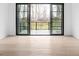 Bedroom with hardwood floors and sliding glass doors leading to deck at 10771 Holliday Farms Blvd, Zionsville, IN 46077