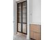 Modern closet with glass doors, wooden shelves, and brass handles at 10771 Holliday Farms Blvd, Zionsville, IN 46077