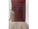 Large walk-in closet with rich burgundy doors and gold hardware at 10771 Holliday Farms Blvd, Zionsville, IN 46077